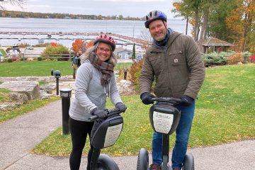 a man and a woman sitting on a motorcycle